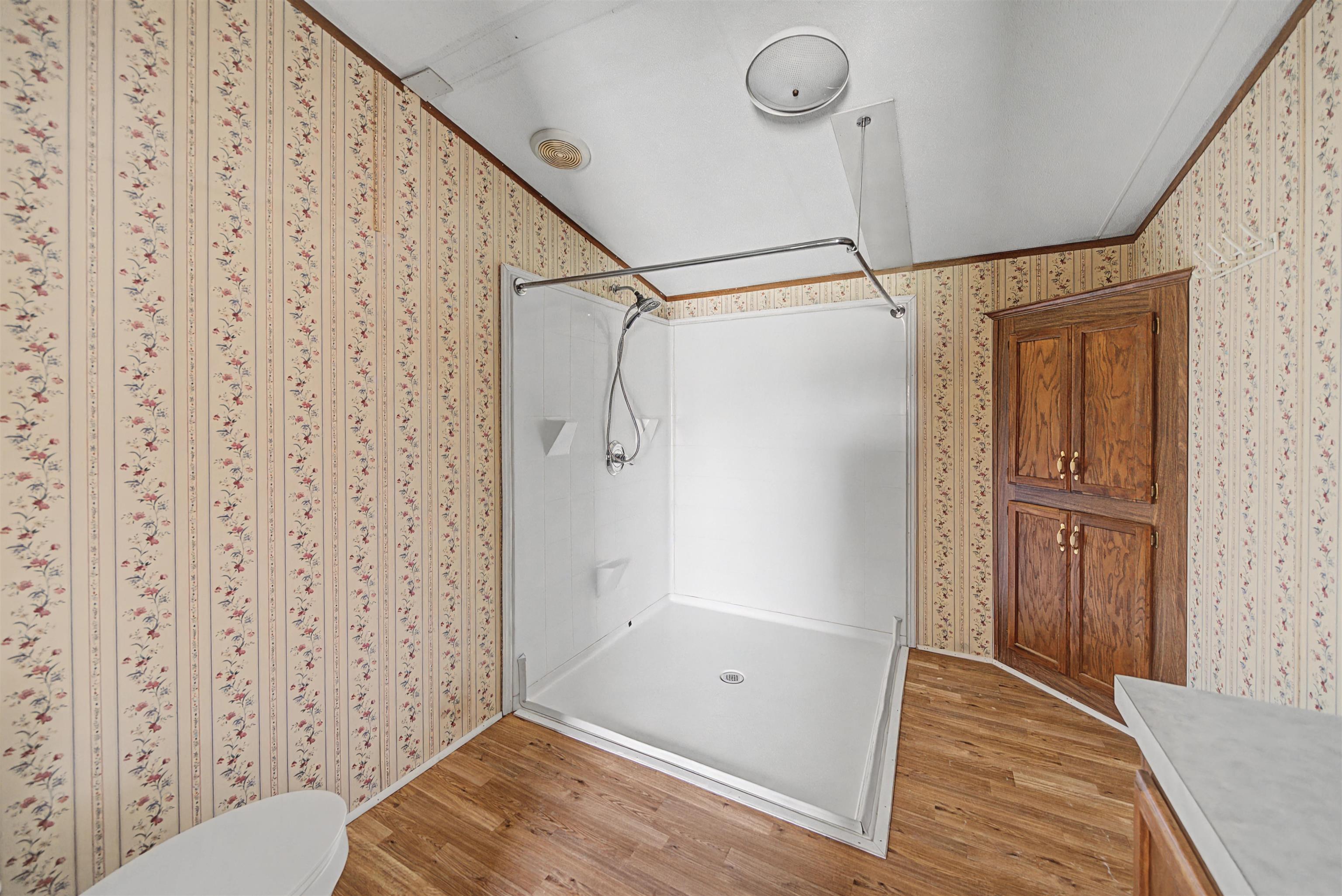 1788 Nichols Road Guys, TN 38339 - Photo 20 of 21 Full bath featuring a stall shower, light wood-style flooring, and vanity