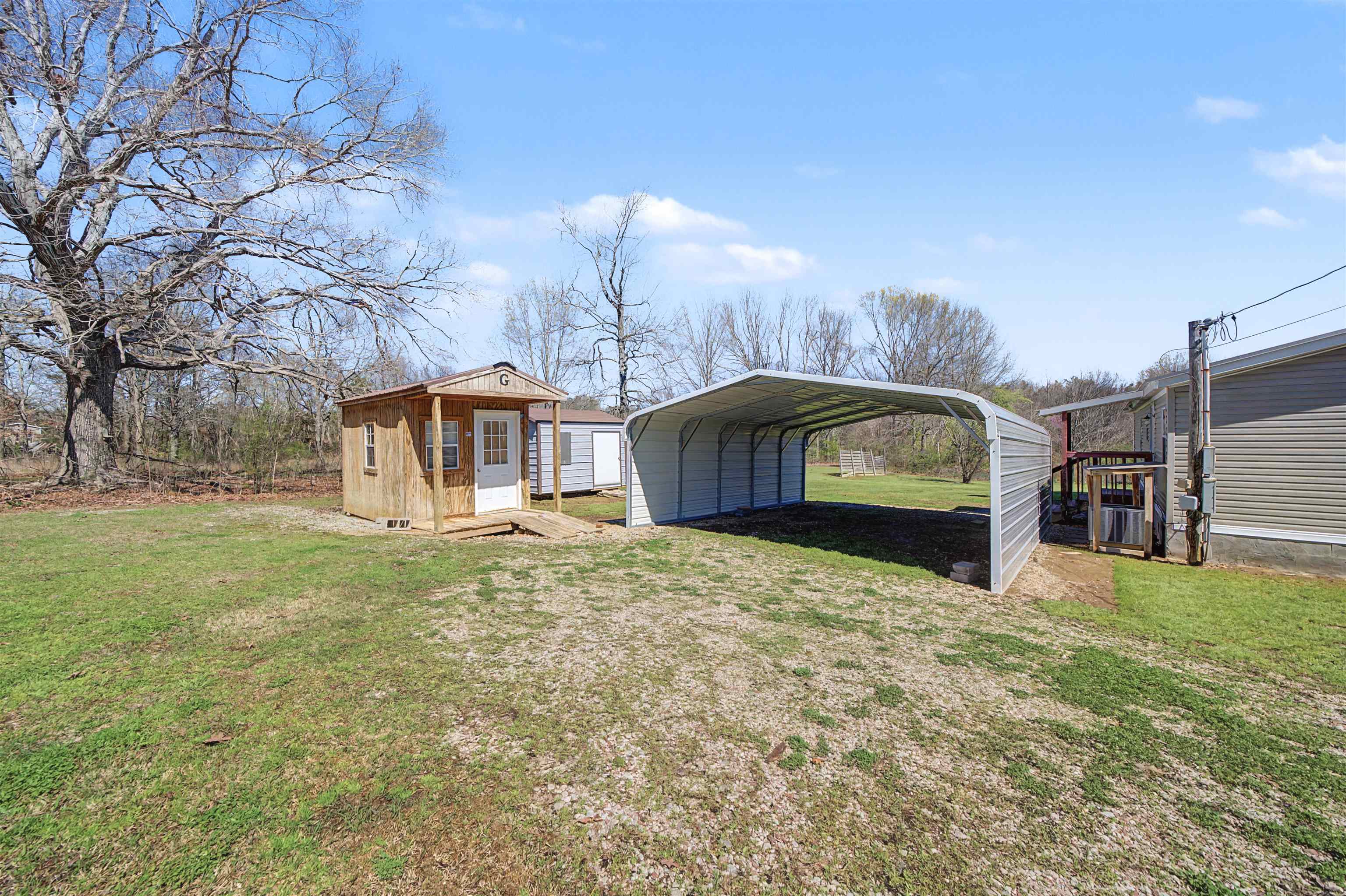 1788 Nichols Road Guys, TN 38339 - Photo 8 of 21 View of green lawn with a detached carport and a storage shed