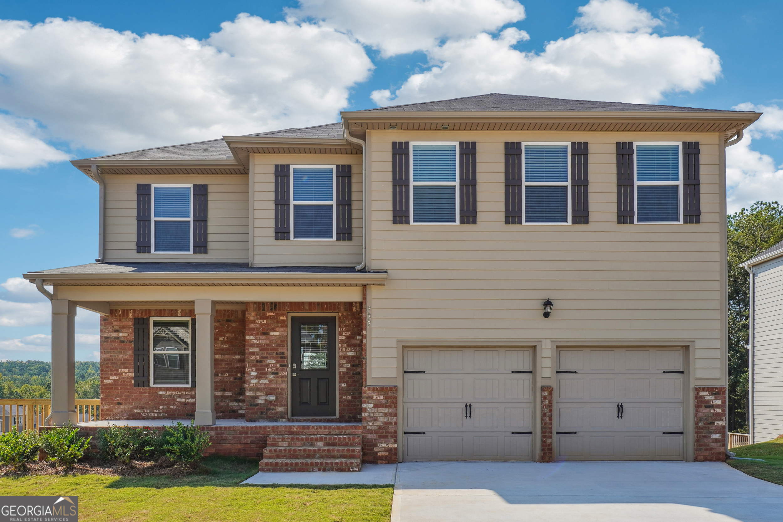 737 Great Oak Place, Unit 73 Villa Rica, GA 30180 - Photo 1 of 1 a view of a brick building next to a yard