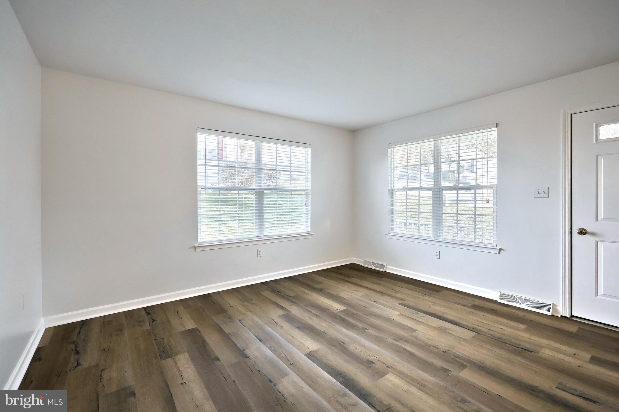 7220 Seneca Ridge Drive York, PA 17403 - Photo 9 of 51 a view of an empty room with wooden floor and a window