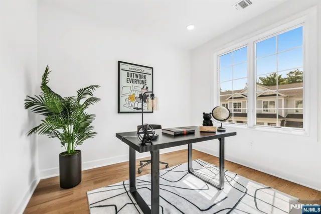 a view of a workspace with furniture and a potted plant