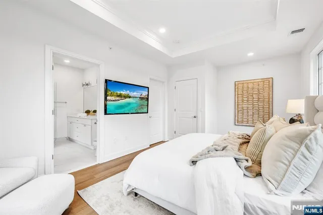 a bedroom with a bed and a flat screen tv