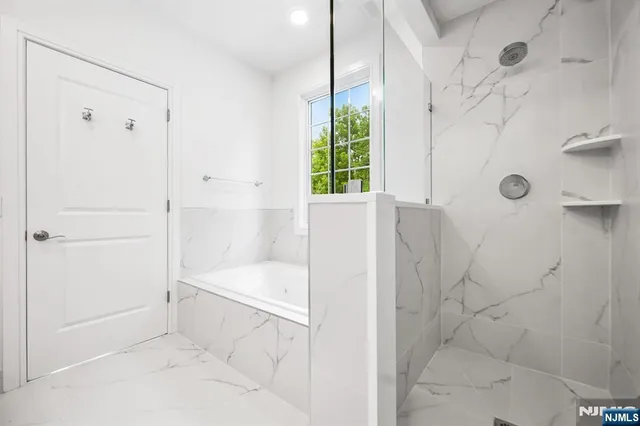 a bathroom with a bathtub and shower