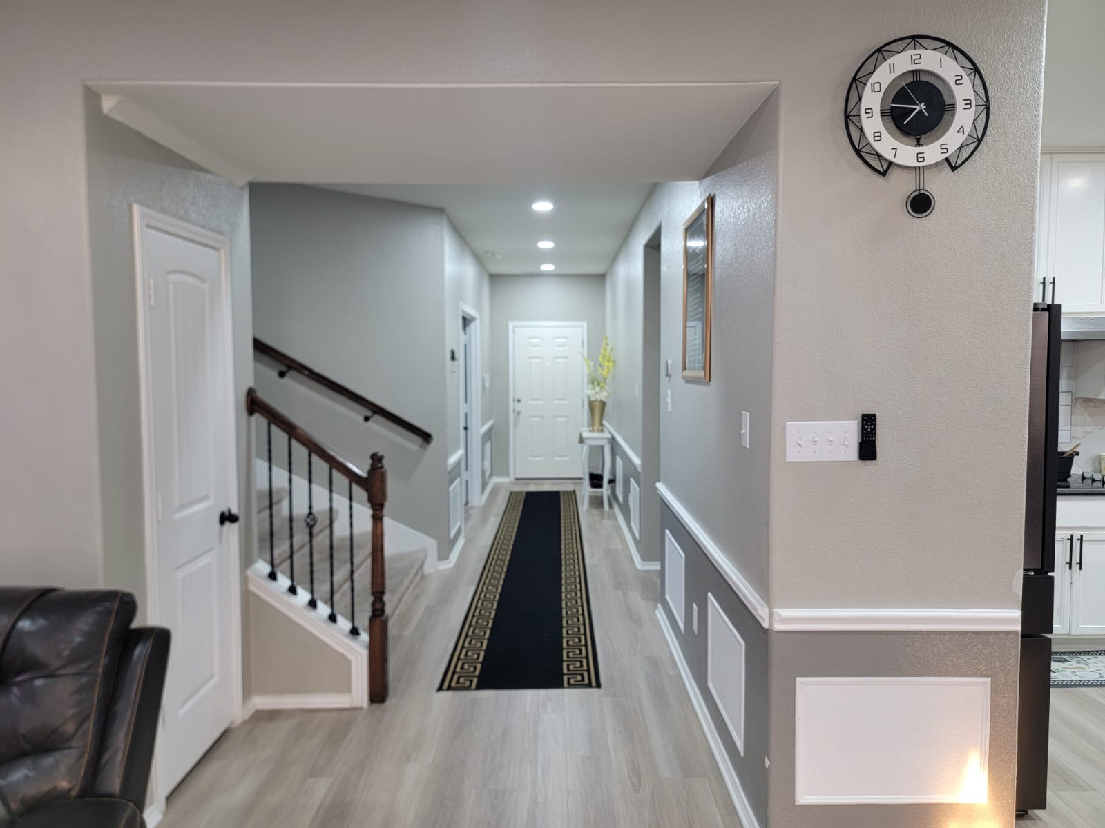 429 Unforgiven Lane Jarrell, TX 76537 - Photo 2 of 10 Hallway featuring recessed lighting, chair rail molding, light wood-finish flooring, and a staircase with dark wood handrails and wrought iron balusters