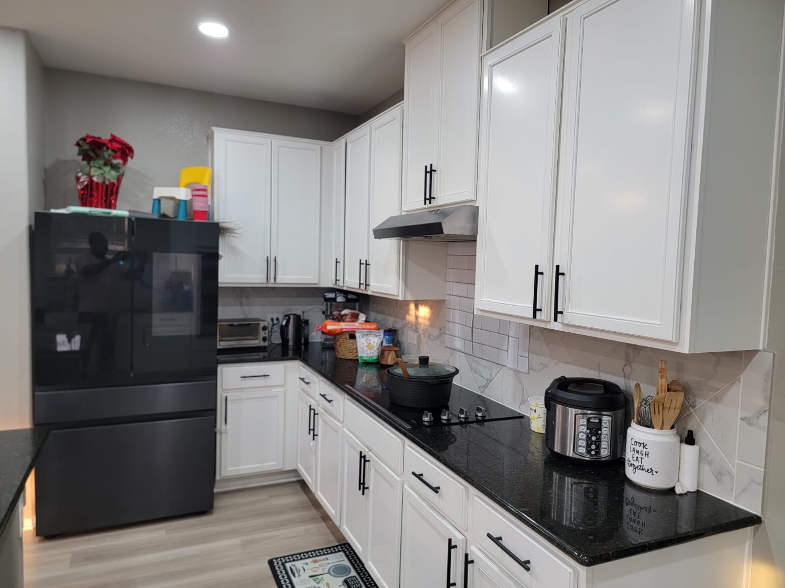429 Unforgiven Lane Jarrell, TX 76537 - Photo 4 of 10 Kitchen featuring white cabinetry with matte black hardware, dark countertops, and a subway tile backsplash