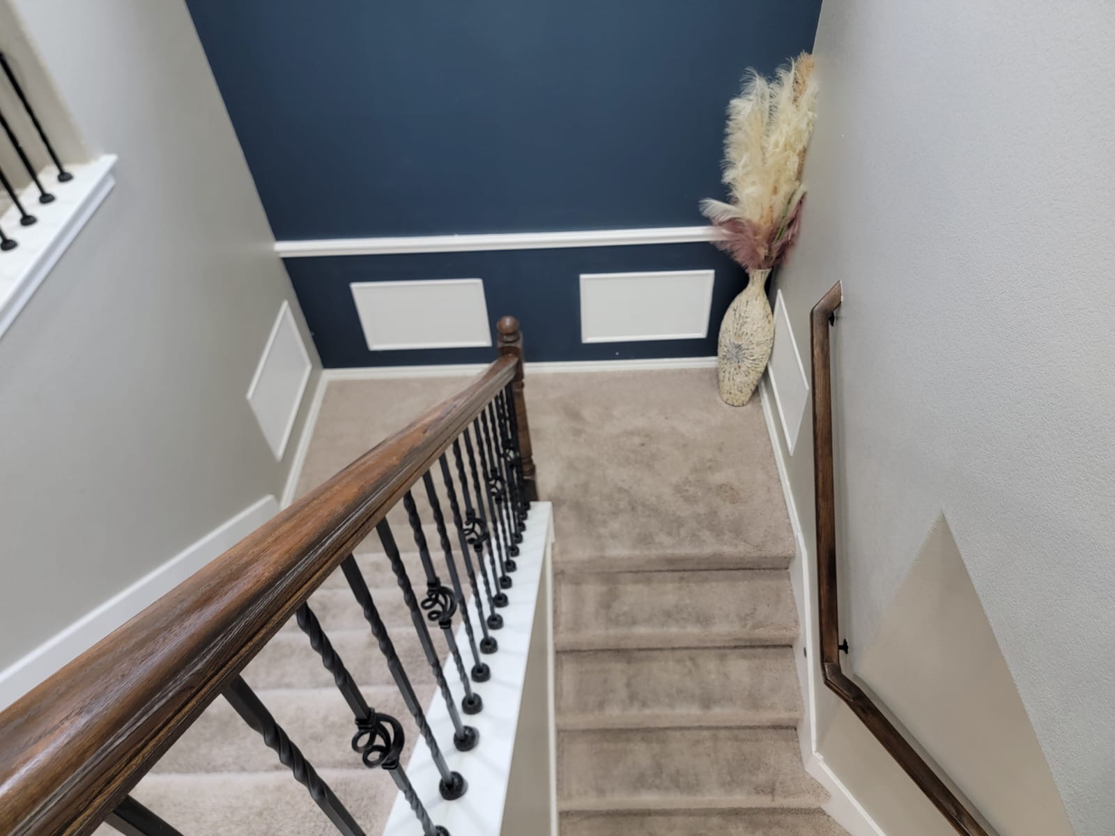 429 Unforgiven Lane Jarrell, TX 76537 - Photo 7 of 10 Carpeted staircase featuring a decorative wrought iron and wood handrail