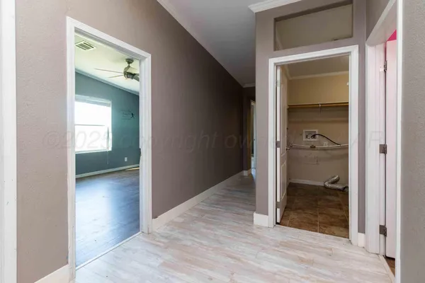 a large kitchen with cabinets wooden floor and stainless steel appliances