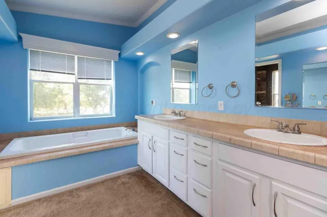 a kitchen with a sink cabinets and window