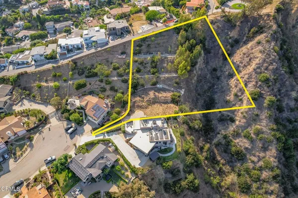 an aerial view of a house with outdoor space