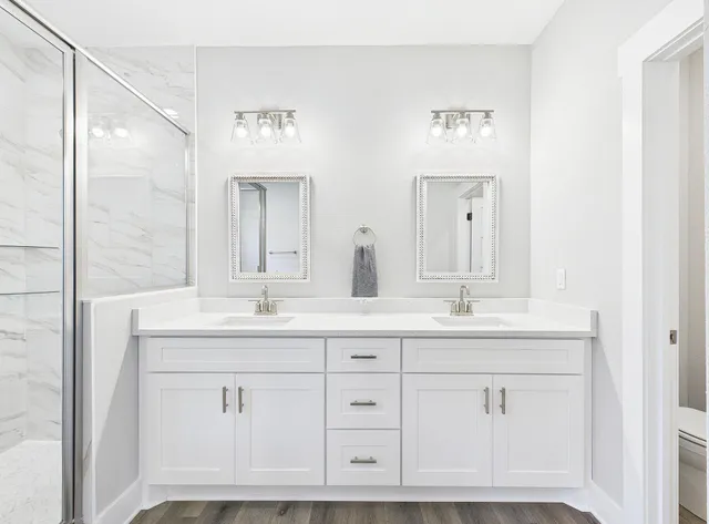 a bathroom with a double vanity sink and a mirror