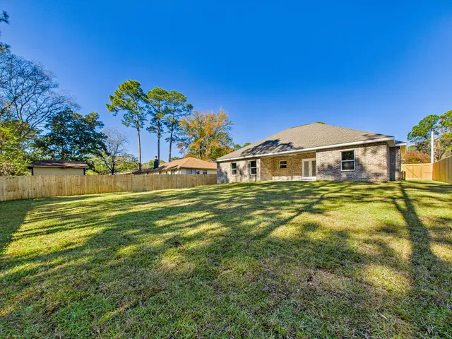 a front view of a house with a big yard