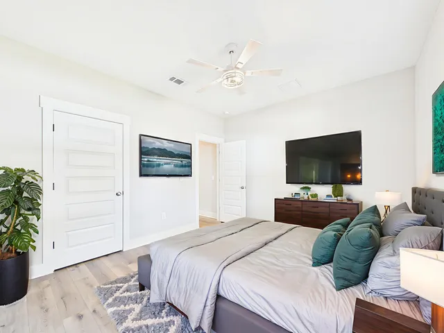 a bedroom with a bed and a flat screen tv