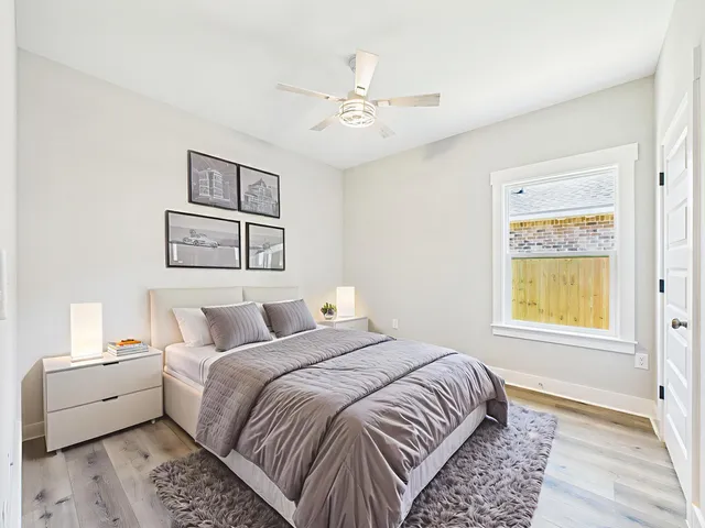 a bedroom with a large bed and a window