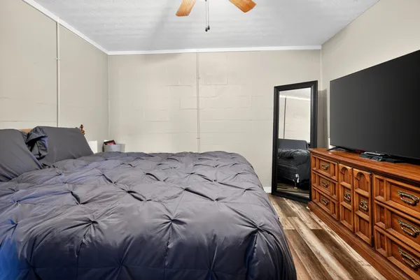 a bedroom with a bed and a flat screen tv