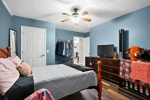 a bedroom with a bed and a flat screen tv