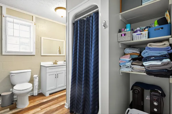 a bathroom with a toilet a sink and a shower