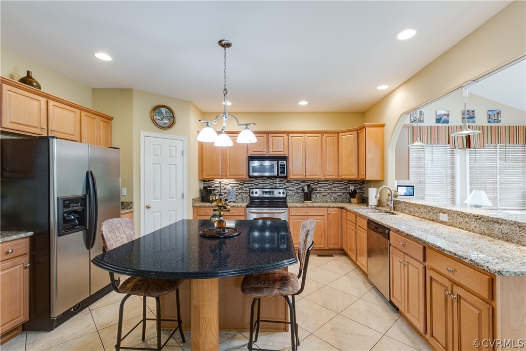 5924 Springmount Road Chesterfield, VA 23832 - Photo 17 of 49 a kitchen with stainless steel appliances granite countertop a kitchen island a stove a table and chairs