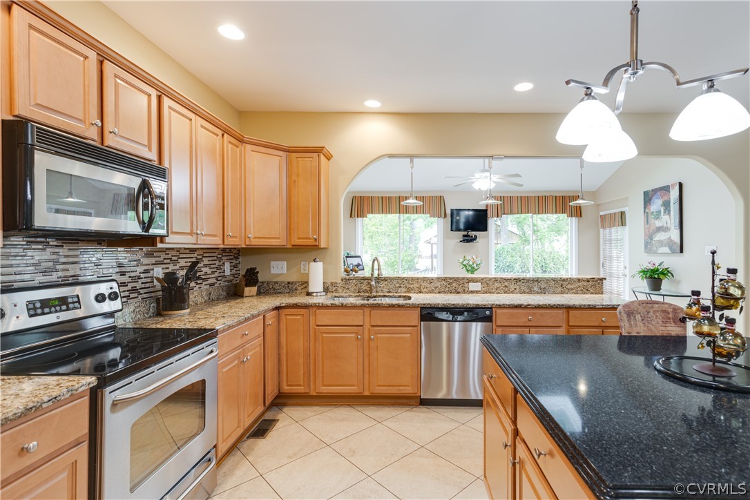 5924 Springmount Road Chesterfield, VA 23832 - Photo 19 of 49 a kitchen with stainless steel appliances granite countertop a sink a stove top oven a counter space and cabinets