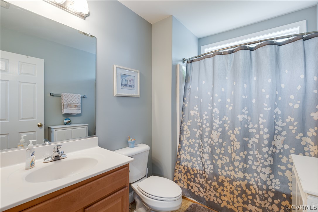 5924 Springmount Road Chesterfield, VA 23832 - Photo 38 of 49 a bathroom with a sink a toilet and shower curtain