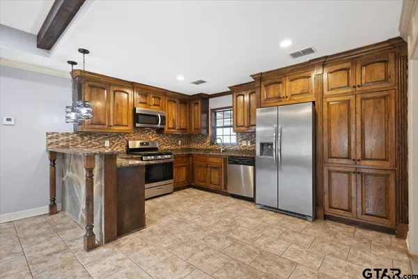 a kitchen with stainless steel appliances granite countertop a refrigerator oven a sink and dishwasher