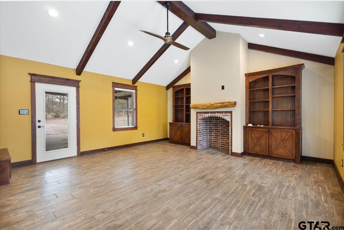 14733 County Road 384 Tyler, TX 75708 - Photo 11 of 38 a view of an empty room with a fireplace and a window