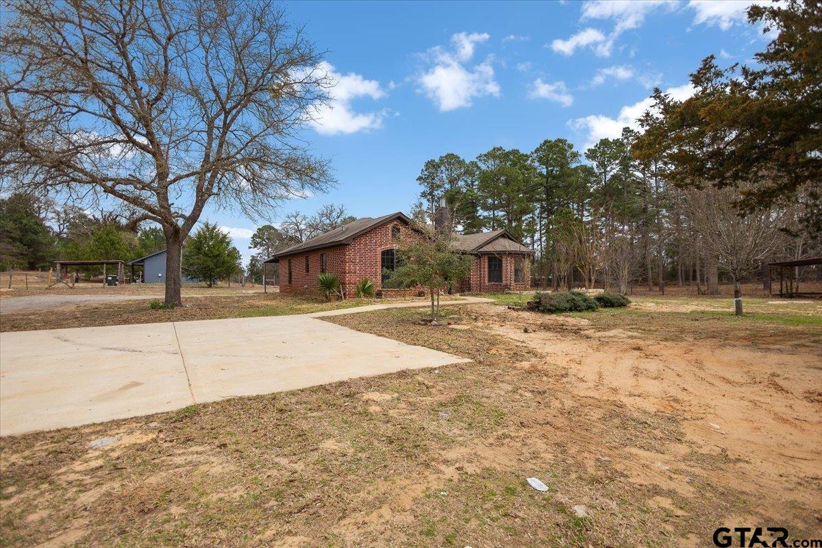 14733 County Road 384 Tyler, TX 75708 - Photo 23 of 38 a house with trees in front of it