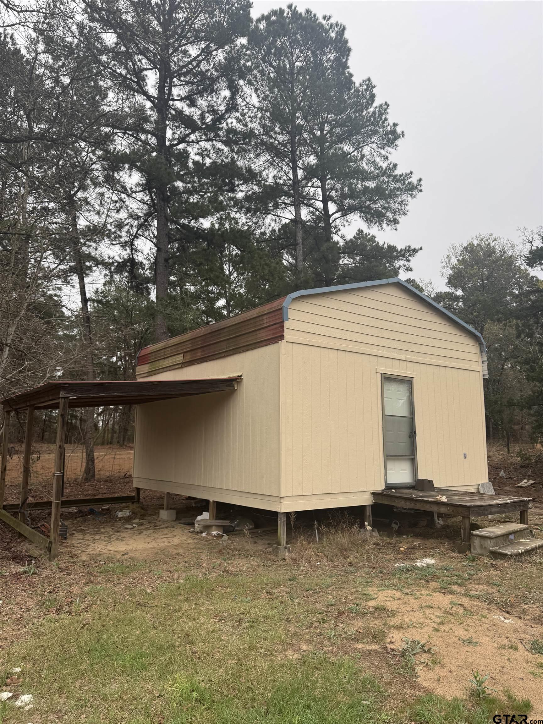 14733 County Road 384 Tyler, TX 75708 - Photo 27 of 38 a house with trees in front of it