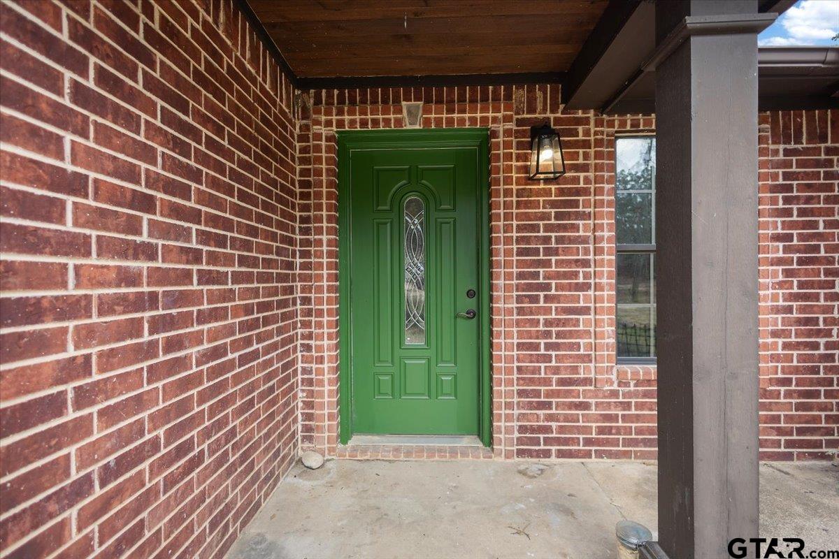14733 County Road 384 Tyler, TX 75708 - Photo 31 of 38 a view of a brick house with a green door