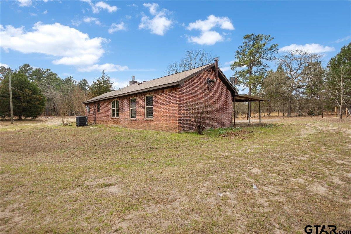 14733 County Road 384 Tyler, TX 75708 - Photo 36 of 38 a front view of house with yard and trees in the background