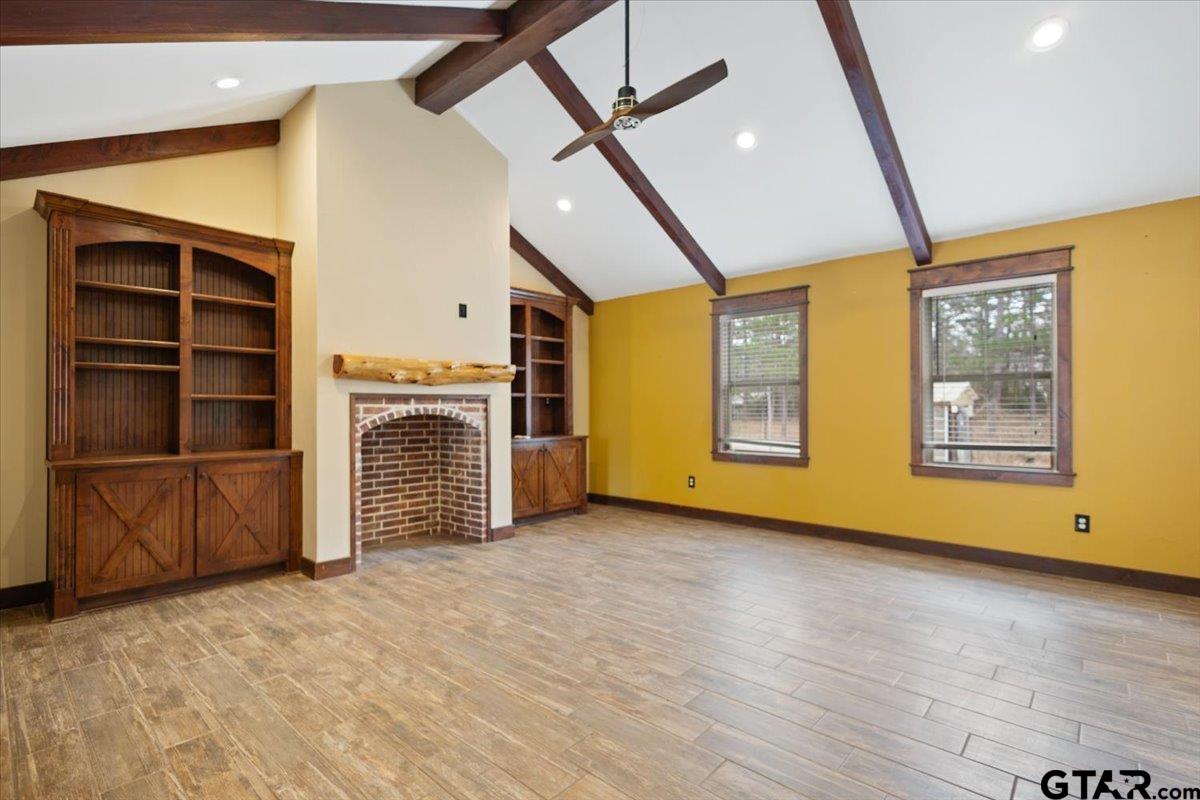 14733 County Road 384 Tyler, TX 75708 - Photo 8 of 38 a view of an empty room with a fireplace and a window