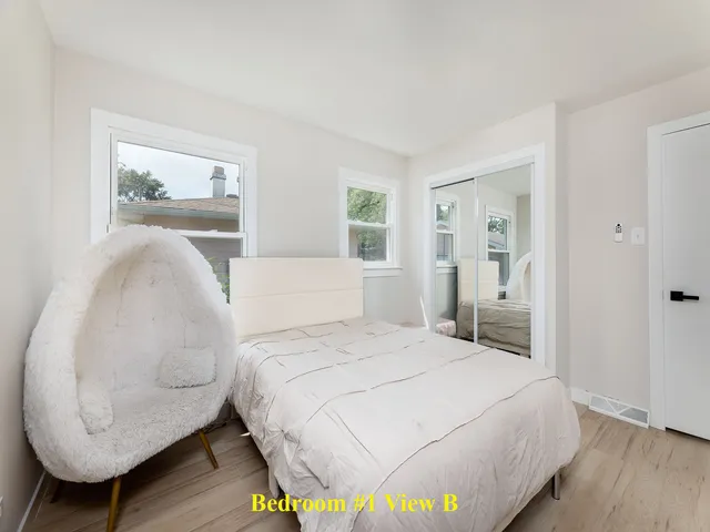 a bedroom with a bed and a painting on the wall