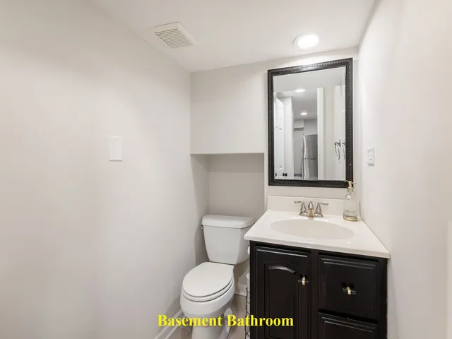 a bathroom with a sink toilet and mirror