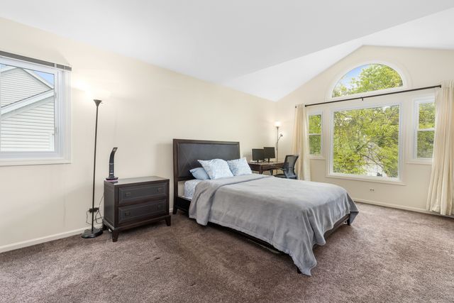 a bed room with a bed and a window