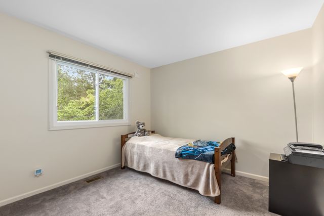 a bed sitting in a room next to a window