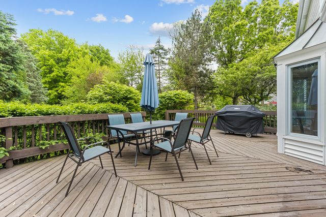 a view of a chairs and table on the wooden deck