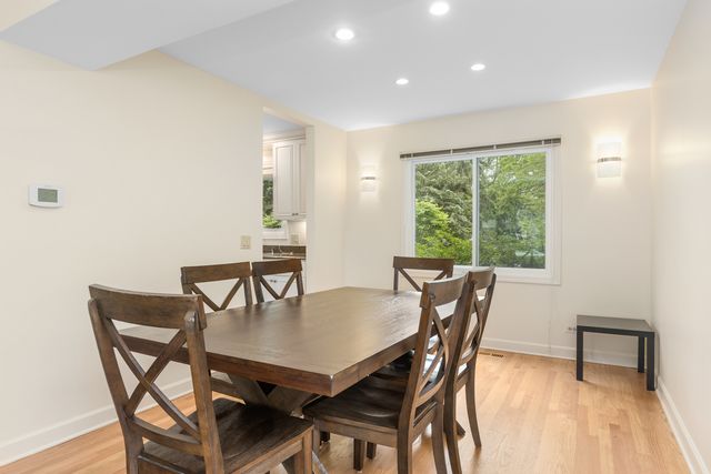 a view of a dining room with furniture and a window
