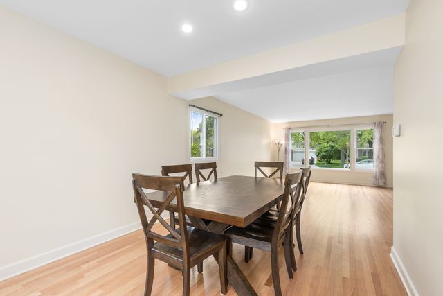 a view of a dining room with furniture and a potted plant