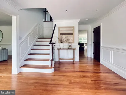 a view of entryway and hall with wooden floor