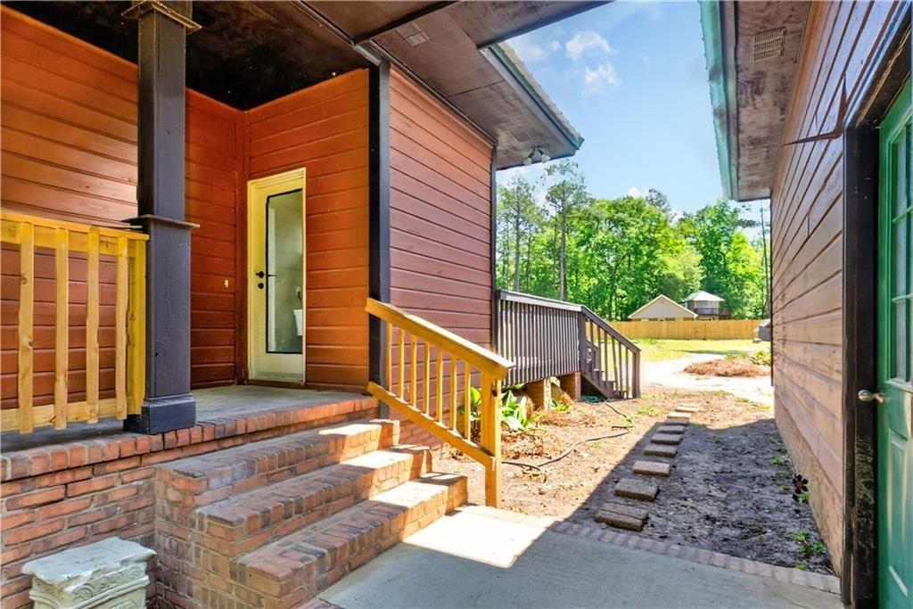 1206 Jasmine Road Dublin, GA 31021 - Photo 27 of 33 a view of a porch with wooden floor and iron stairs