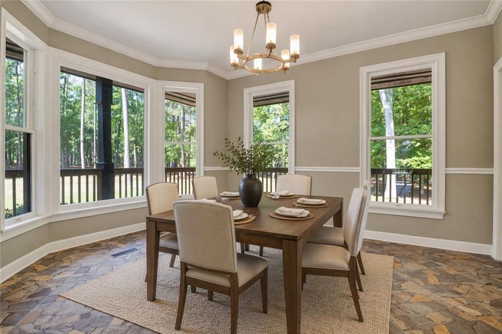 1206 Jasmine Road Dublin, GA 31021 - Photo 5 of 33 a dining room with furniture a chandelier and wooden floor