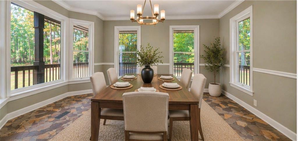 1206 Jasmine Road Dublin, GA 31021 - Photo 6 of 33 a dining room with furniture a chandelier and wooden floor