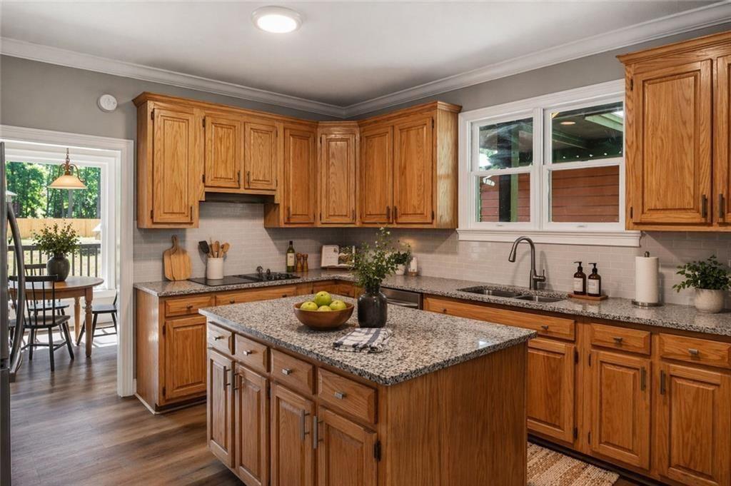 1206 Jasmine Road Dublin, GA 31021 - Photo 7 of 33 a kitchen with granite countertop a sink a counter top space and cabinets