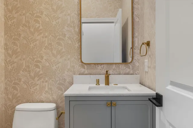 a view of a kitchen with wooden floor and a window