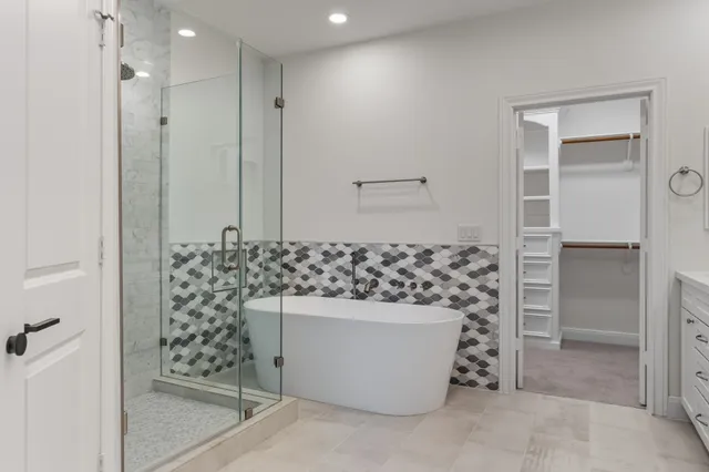 a bathroom with a bathtub sink and mirror