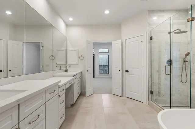 a bathroom with a bathtub and a shower