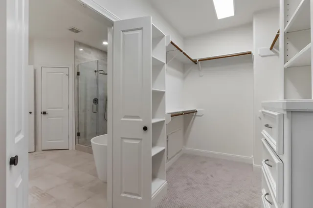 a spacious bathroom with a shower sink and mirror