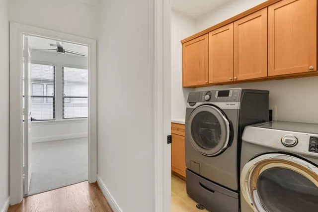 a spacious bathroom with double sink a toilet a a mirror a vanity and a