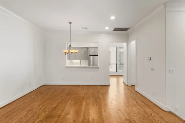 a view of empty room with wooden floor and fireplace