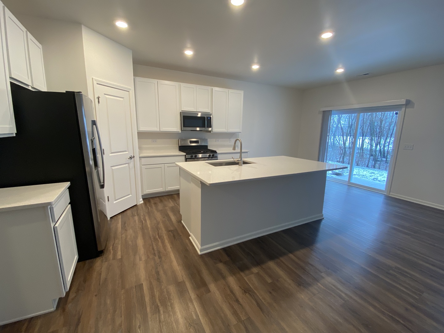 1009 North Draper Road McHenry, IL 60050 - Photo 2 of 20 a kitchen with stainless steel appliances a refrigerator a sink dishwasher and a stove top oven