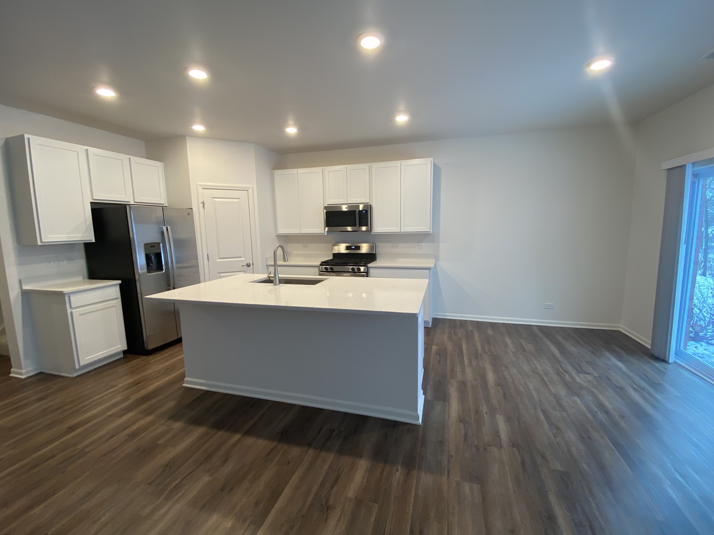 1009 North Draper Road McHenry, IL 60050 - Photo 4 of 20 a room with wooden floors and stainless steel appliances